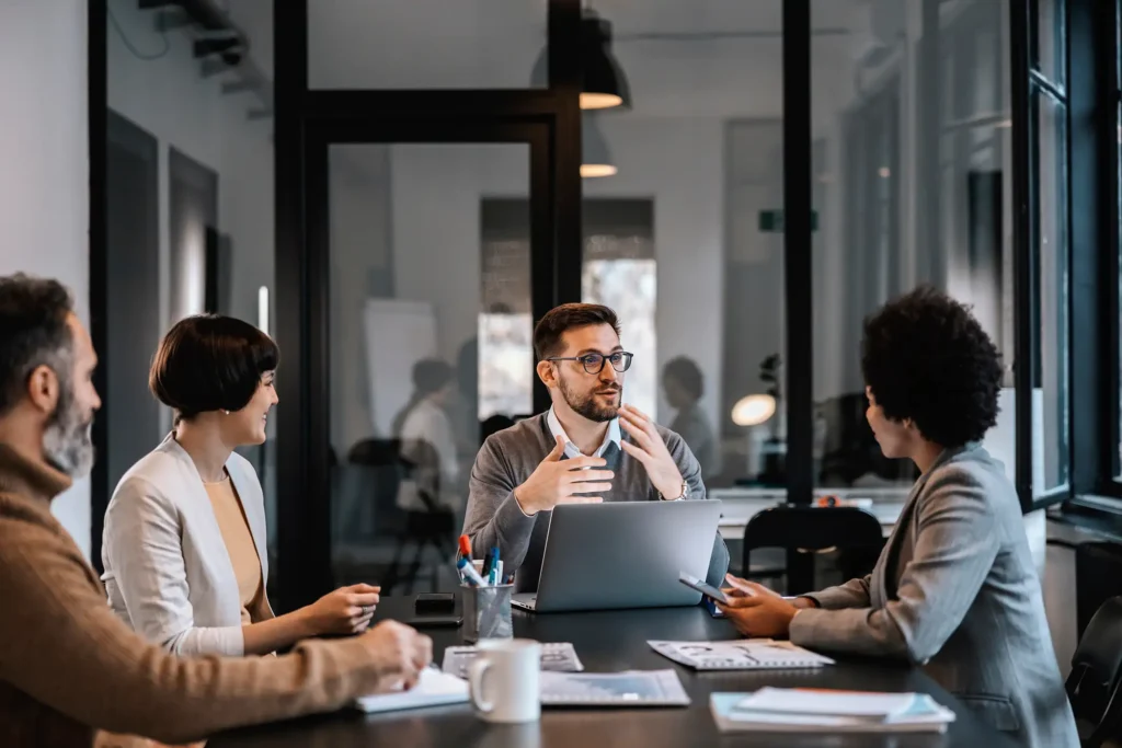 A dedicated mentor is explaining mentees importance of project while sitting at the boardroom